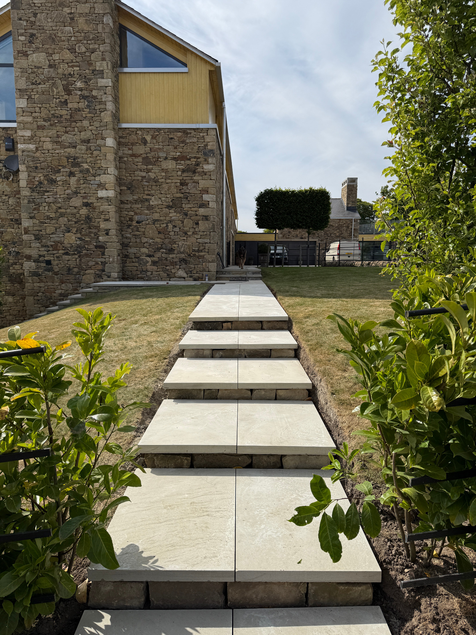 Modern garden pergola over a large paved patio