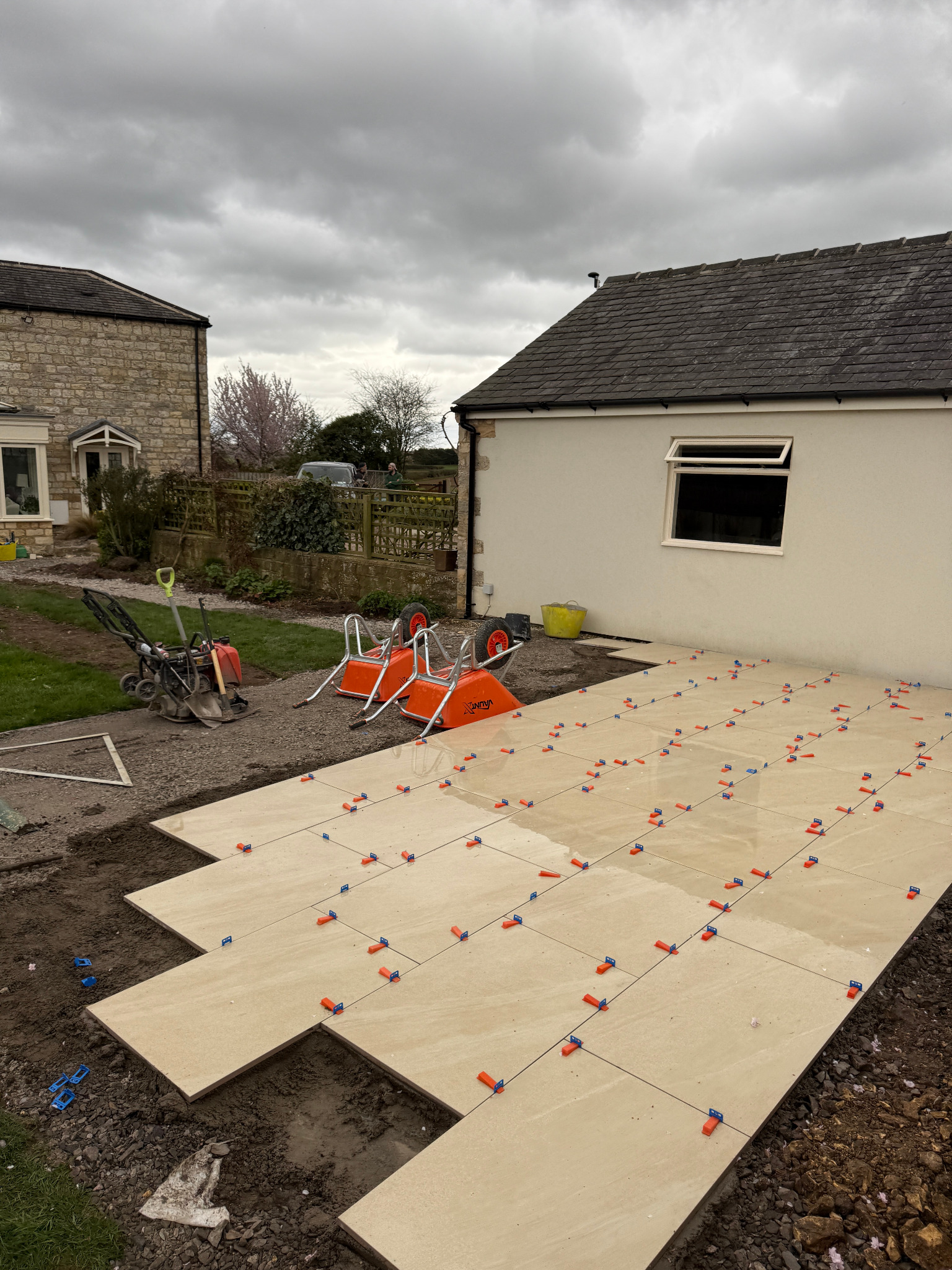 Premium porcelain-style paving and landscaped retaining wall