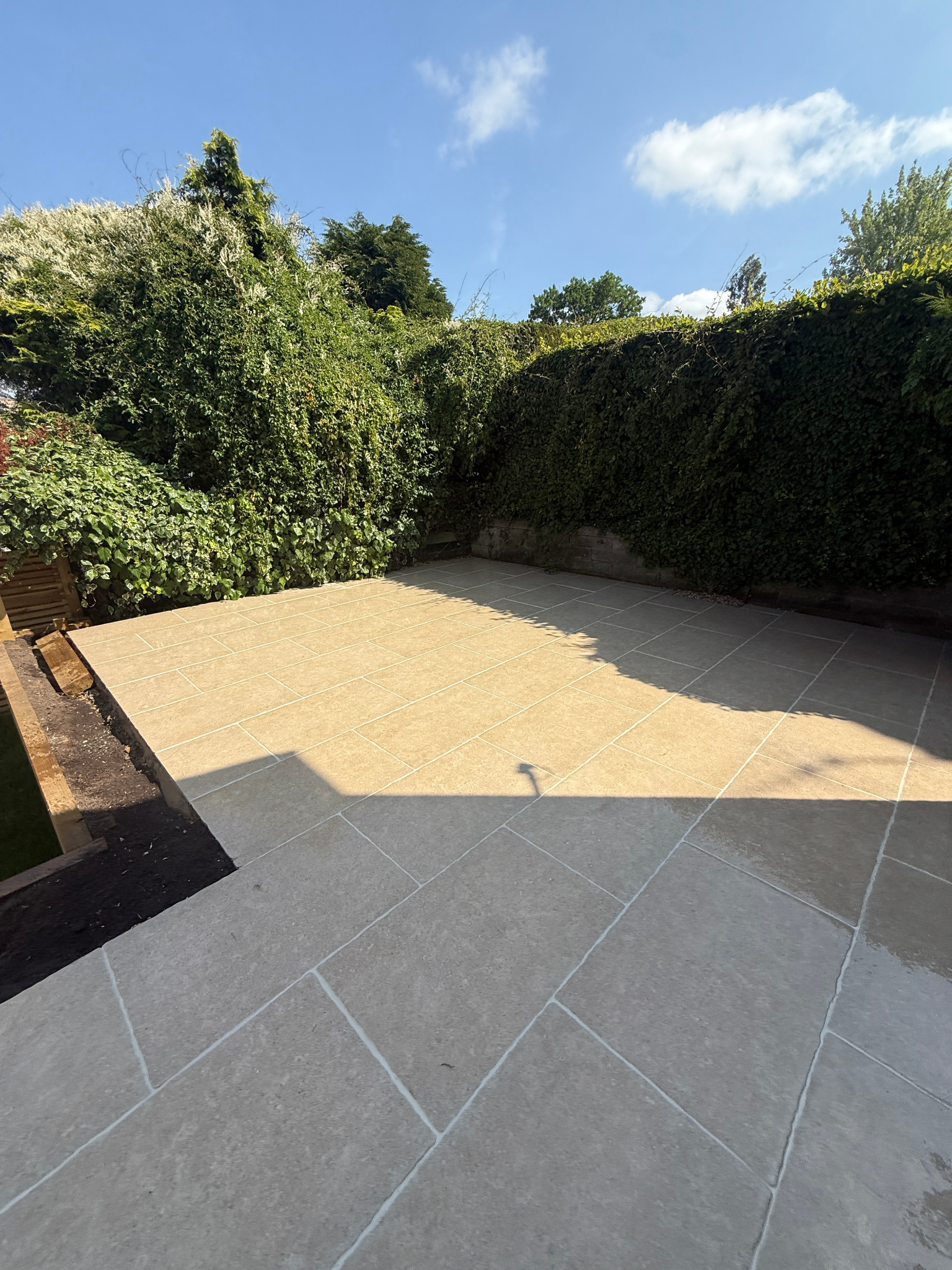 New lawn, timber fencing and paved terraces in a Yorkshire garden