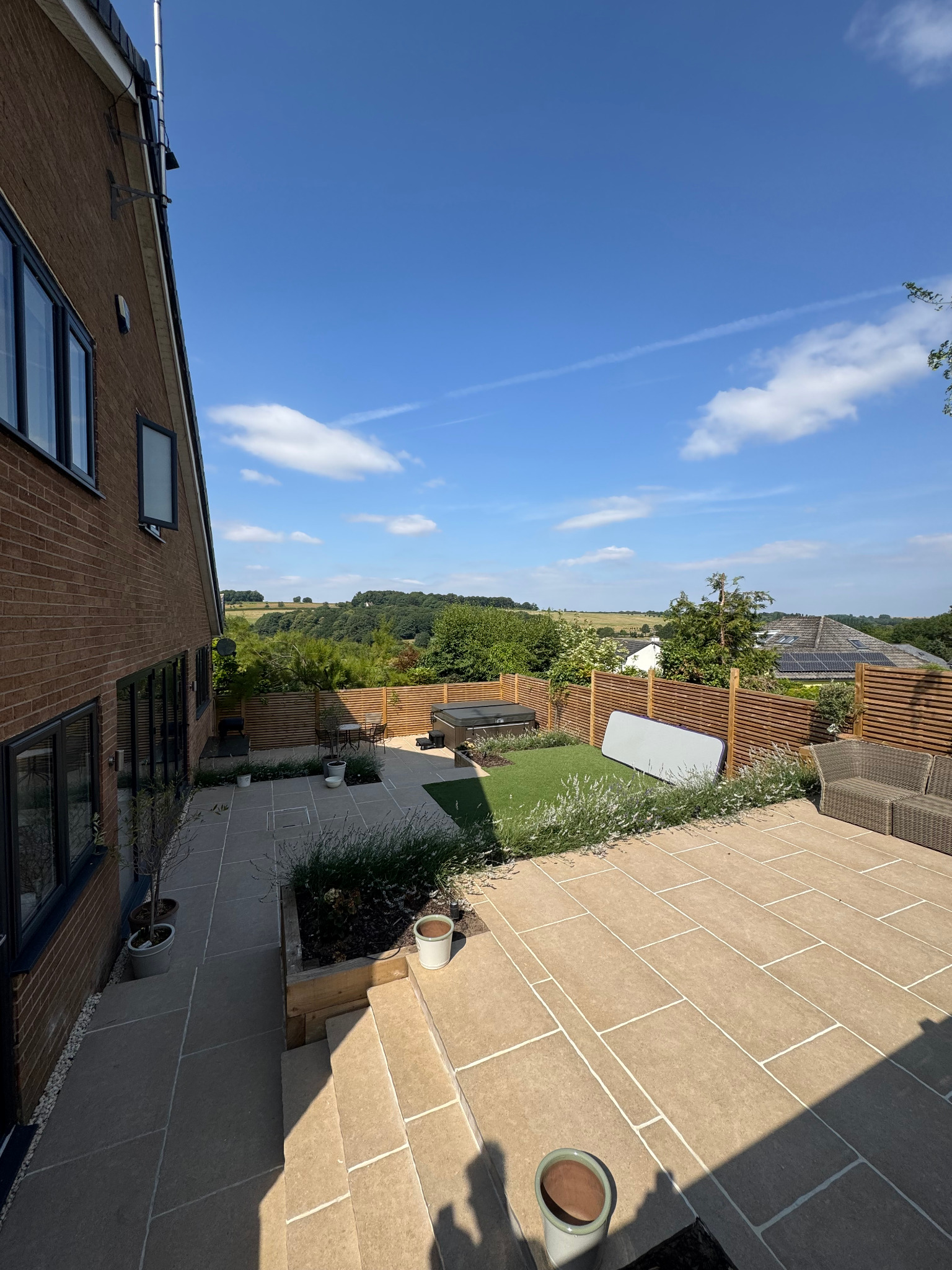 Modern garden pergola over a large paved patio