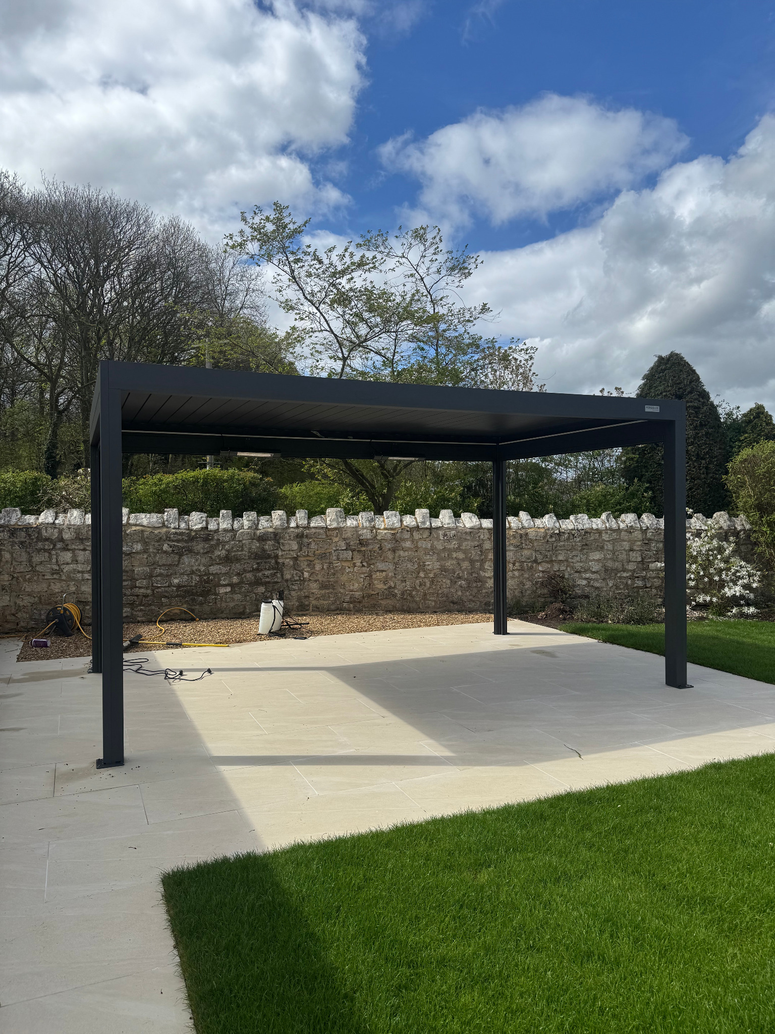 Modern garden pergola over a large paved patio